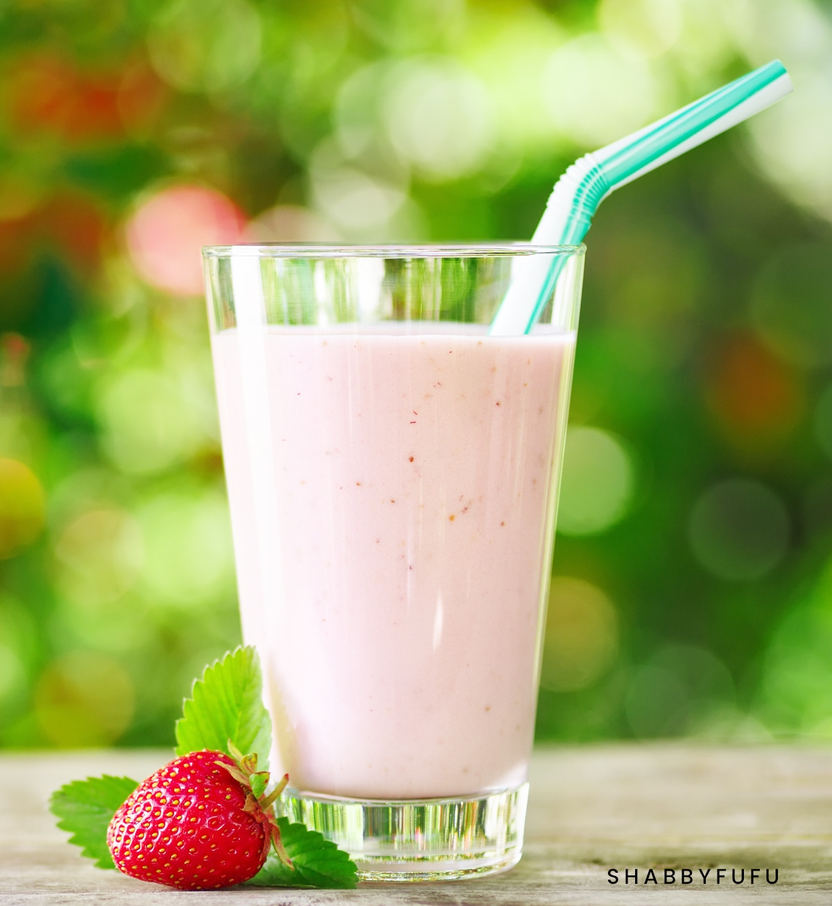 strawberry milkshake in glass on table