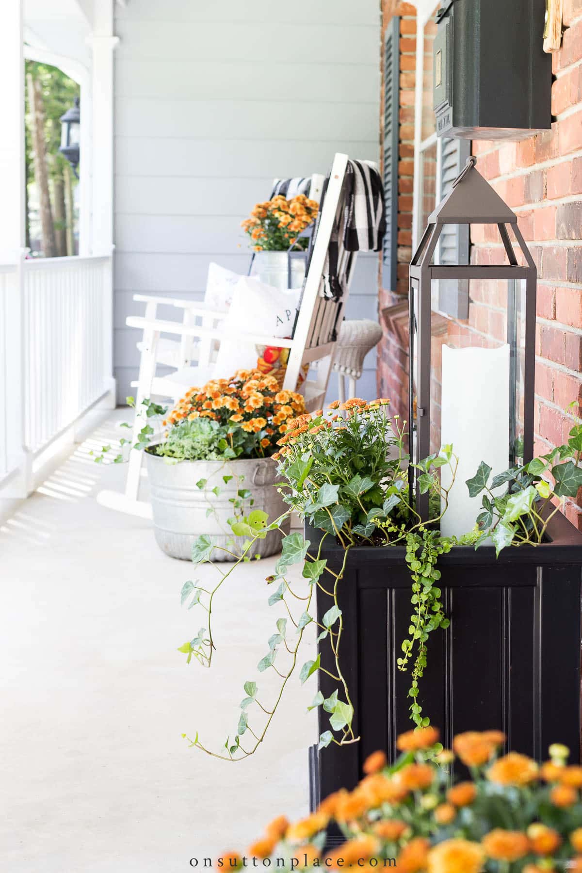 copper mums in planters on front porch 2022