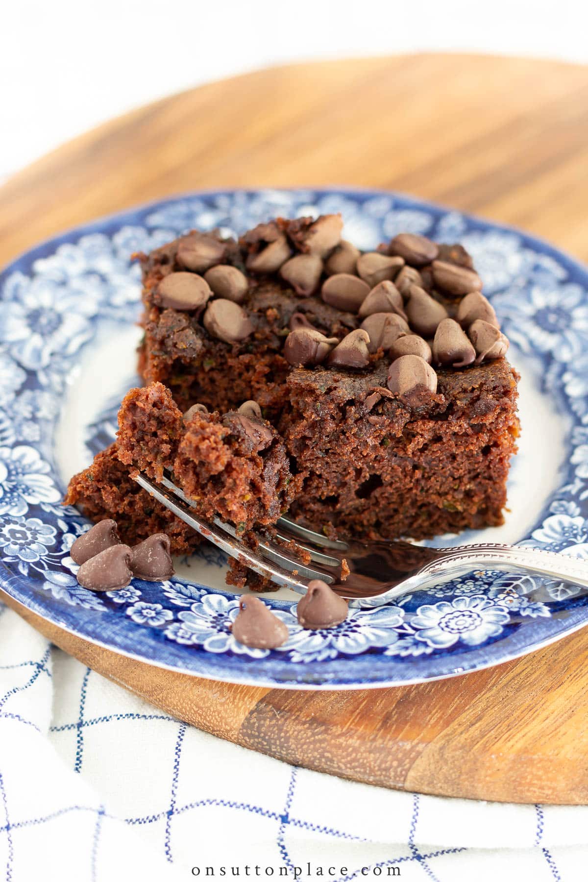 piece of chocolate zucchini cake on blue plate