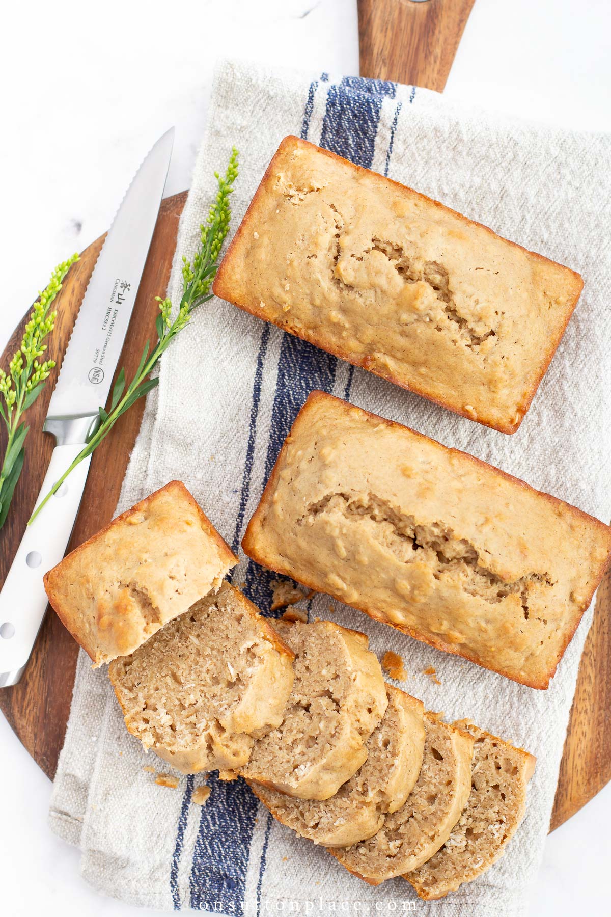 applesauce bread on round wood board with knife