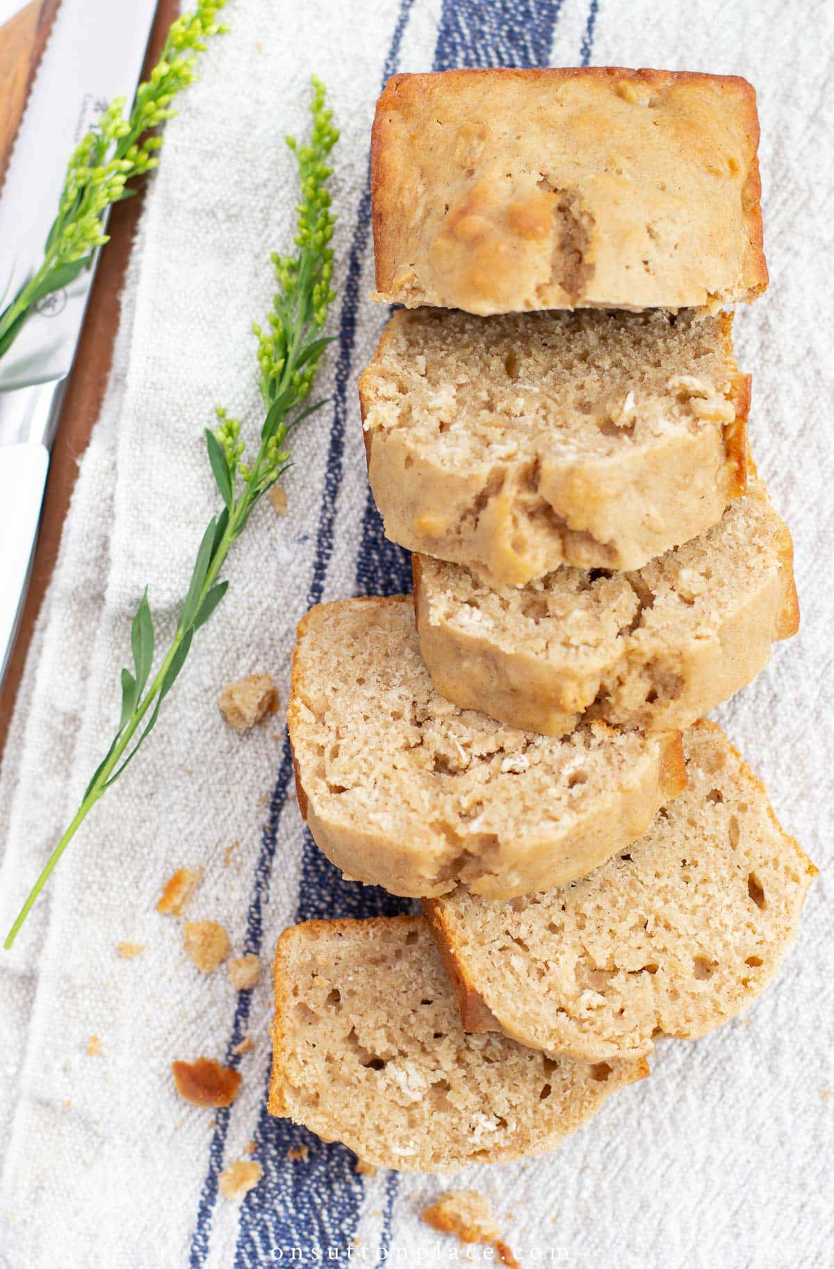 sliced loaf of applesauce bread on grain sack towel