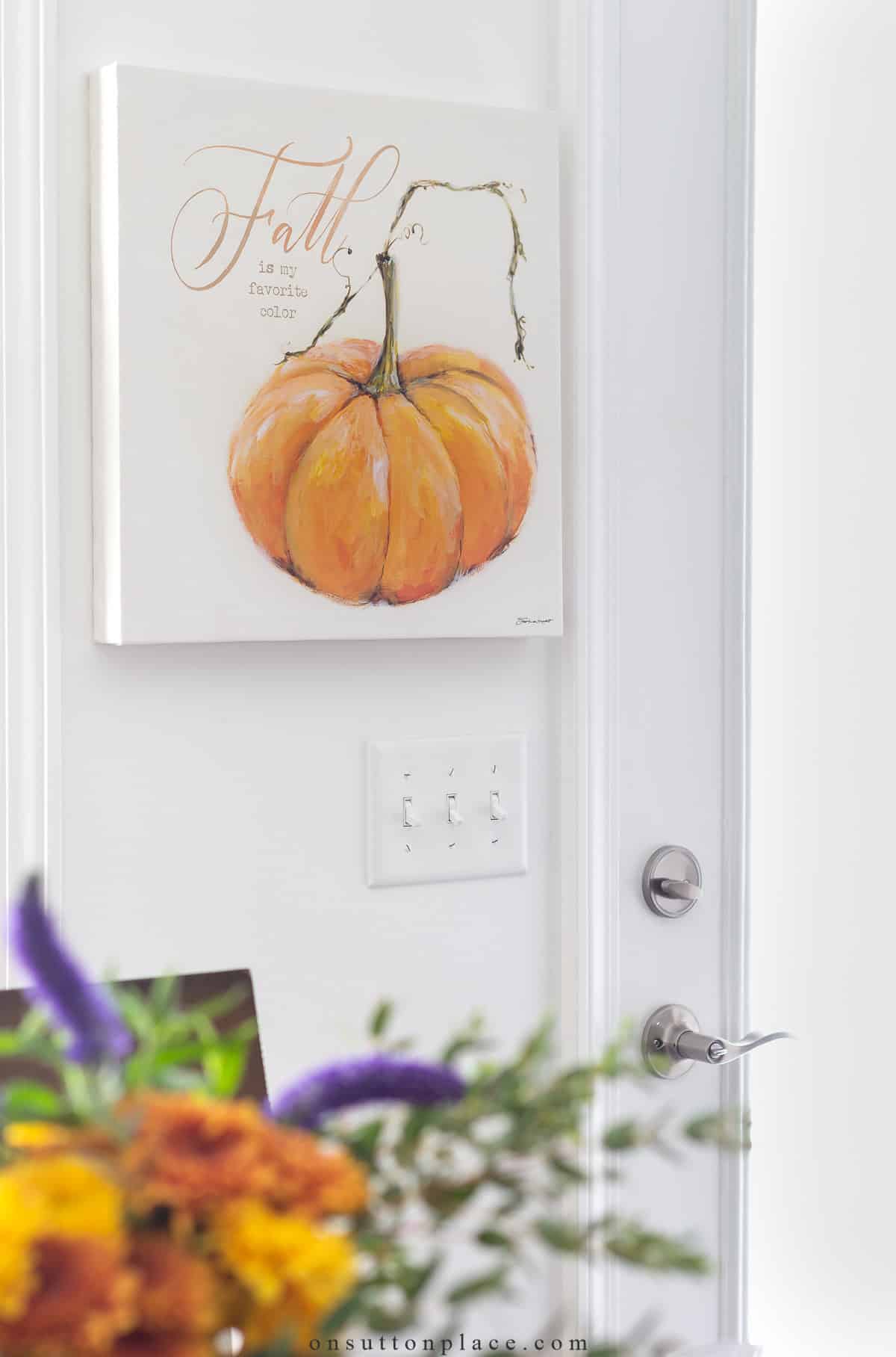 square canvas artwork of pumpkin on wall