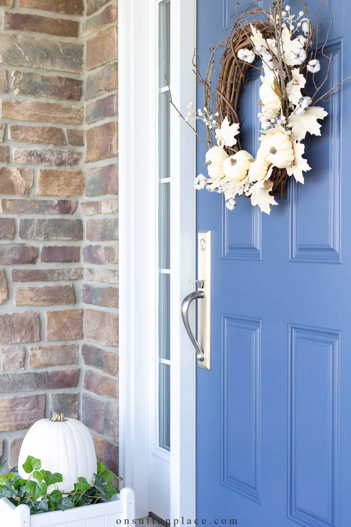 white pumpkin wreath on blue door