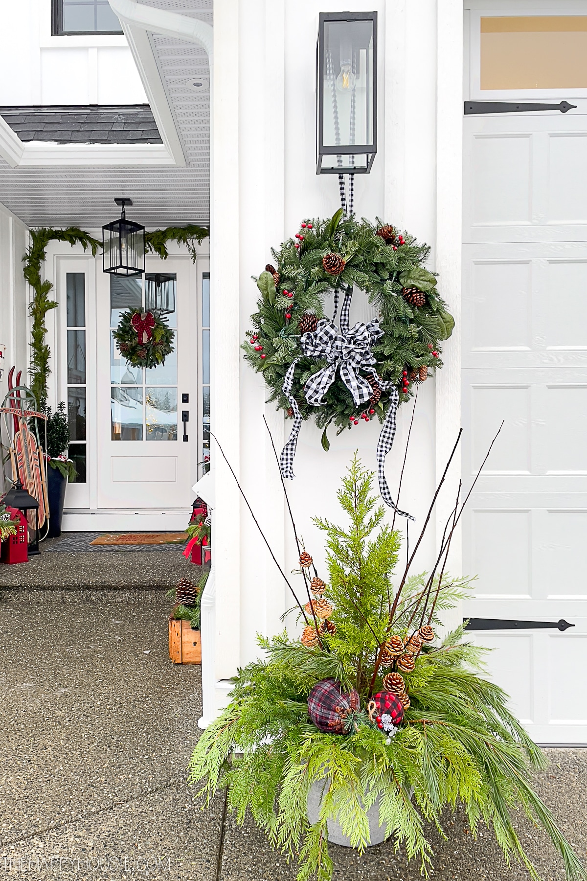 Christmas porch with wreaths and planters