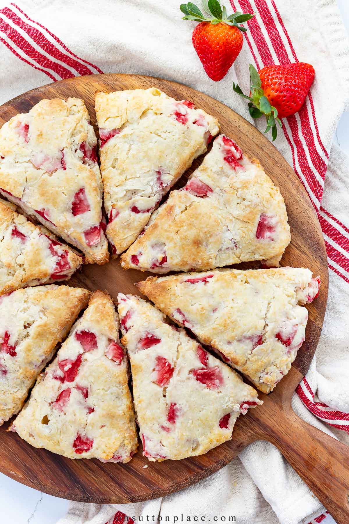 strawberry scones on round wood board