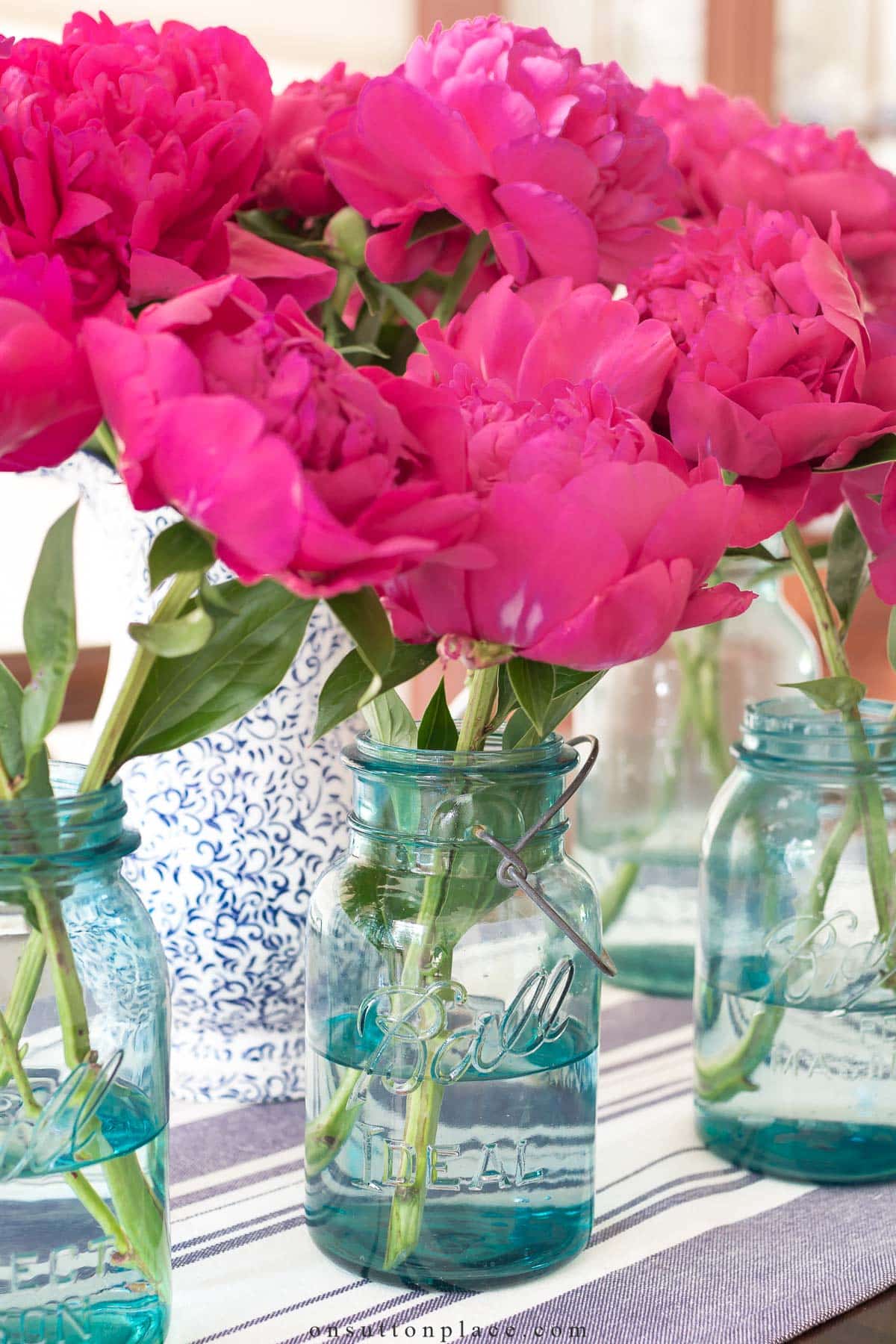 dark pink peonies in vintage blue mason jars www
