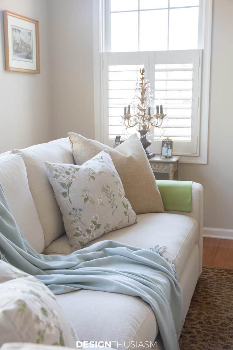 spring living room with pale aqua throw and soft pillows