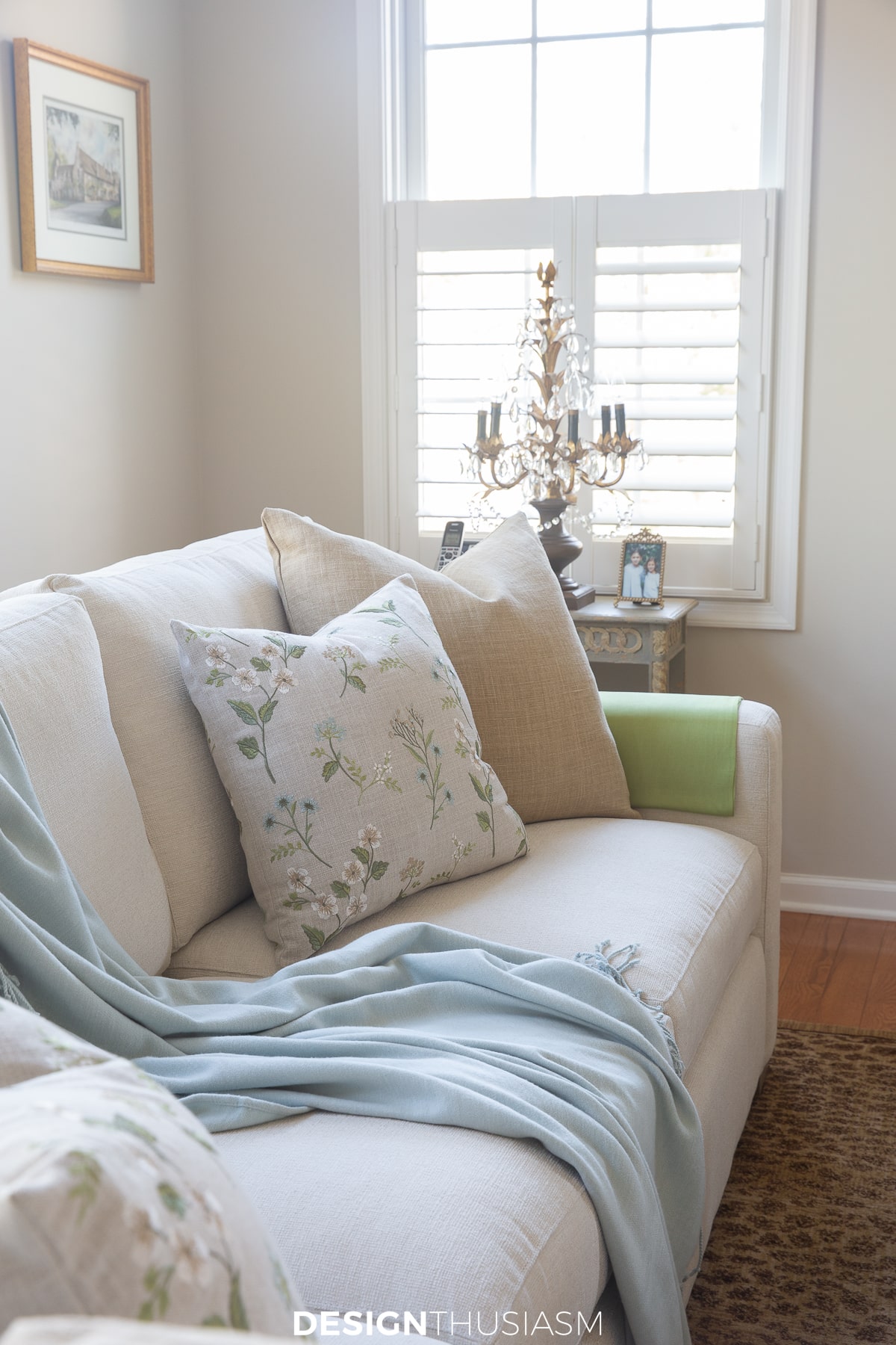 spring living room with pale aqua throw and soft pillows