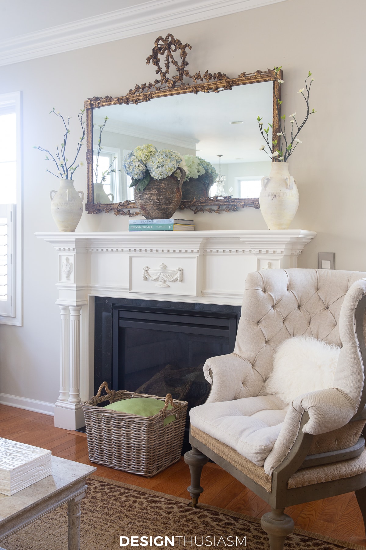 spring mantel with branches and pale blue hydrangeas