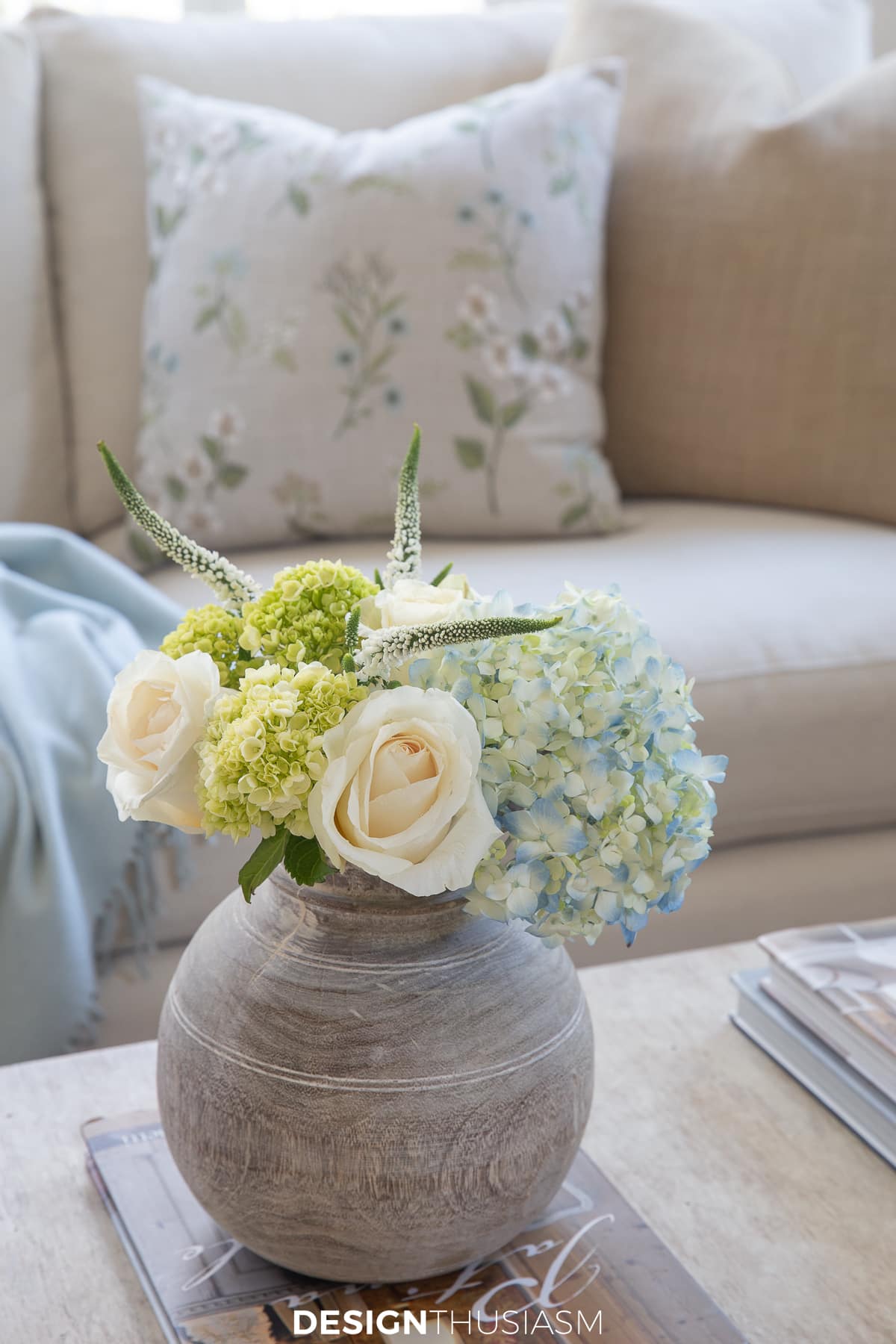 fresh flowers in a bleached wood vase in soft tranquil spring colors