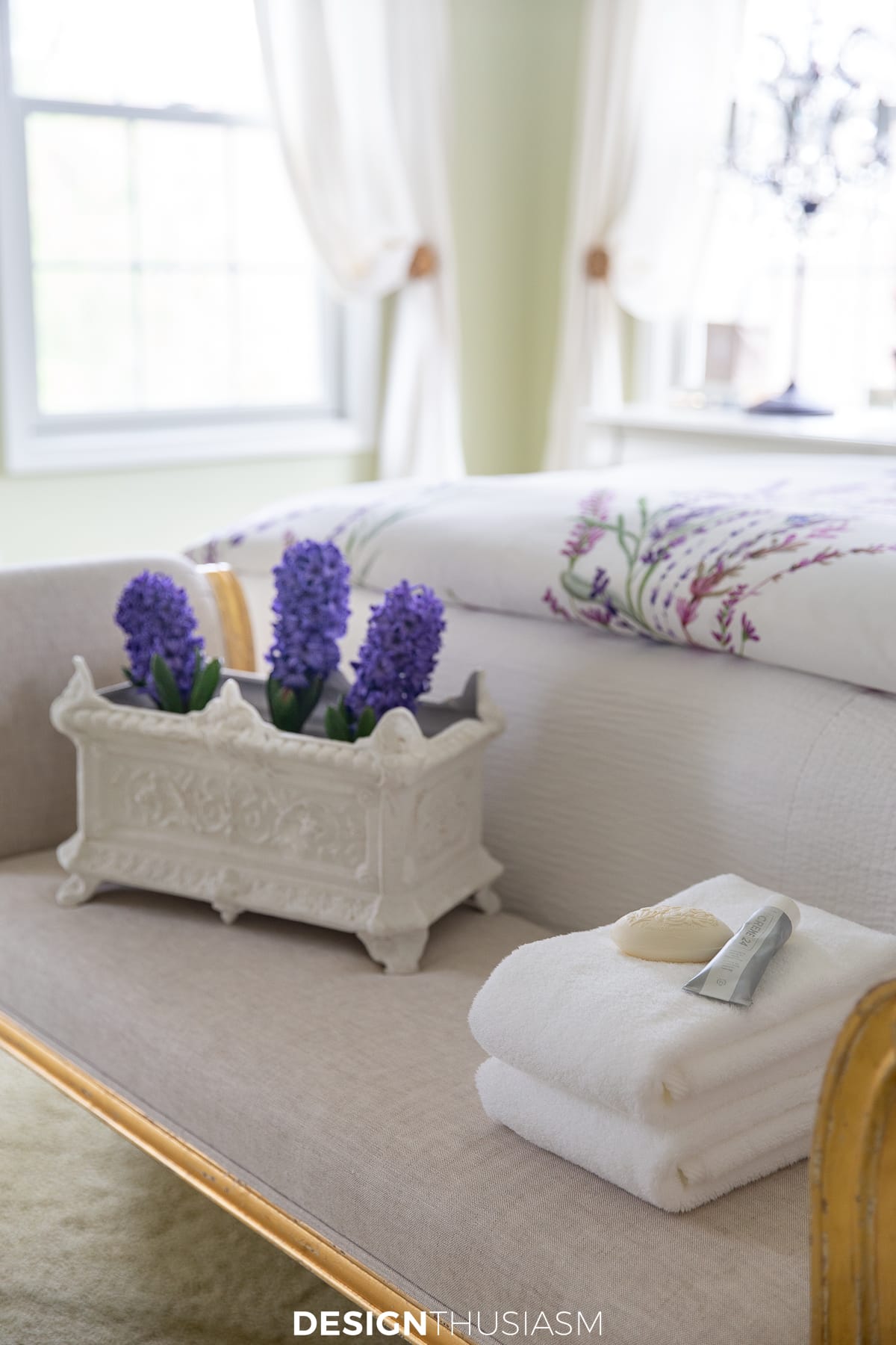bedroom bench with flowers and towels