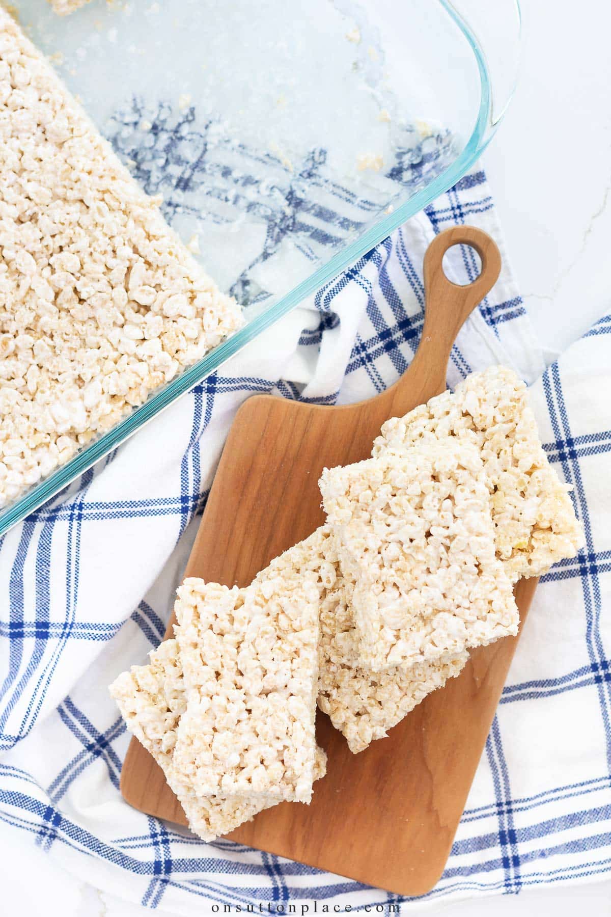 rice krispie treats piled on wood board