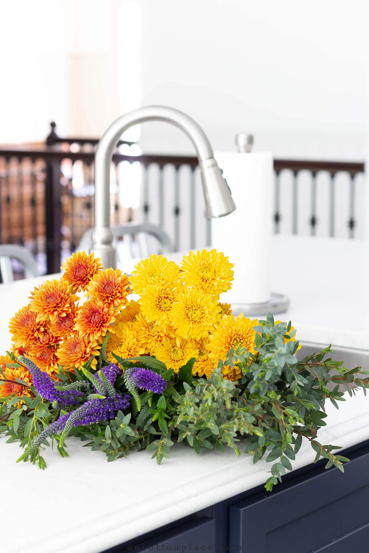 add touches of fall to your kitchen with festive flowers in the sink