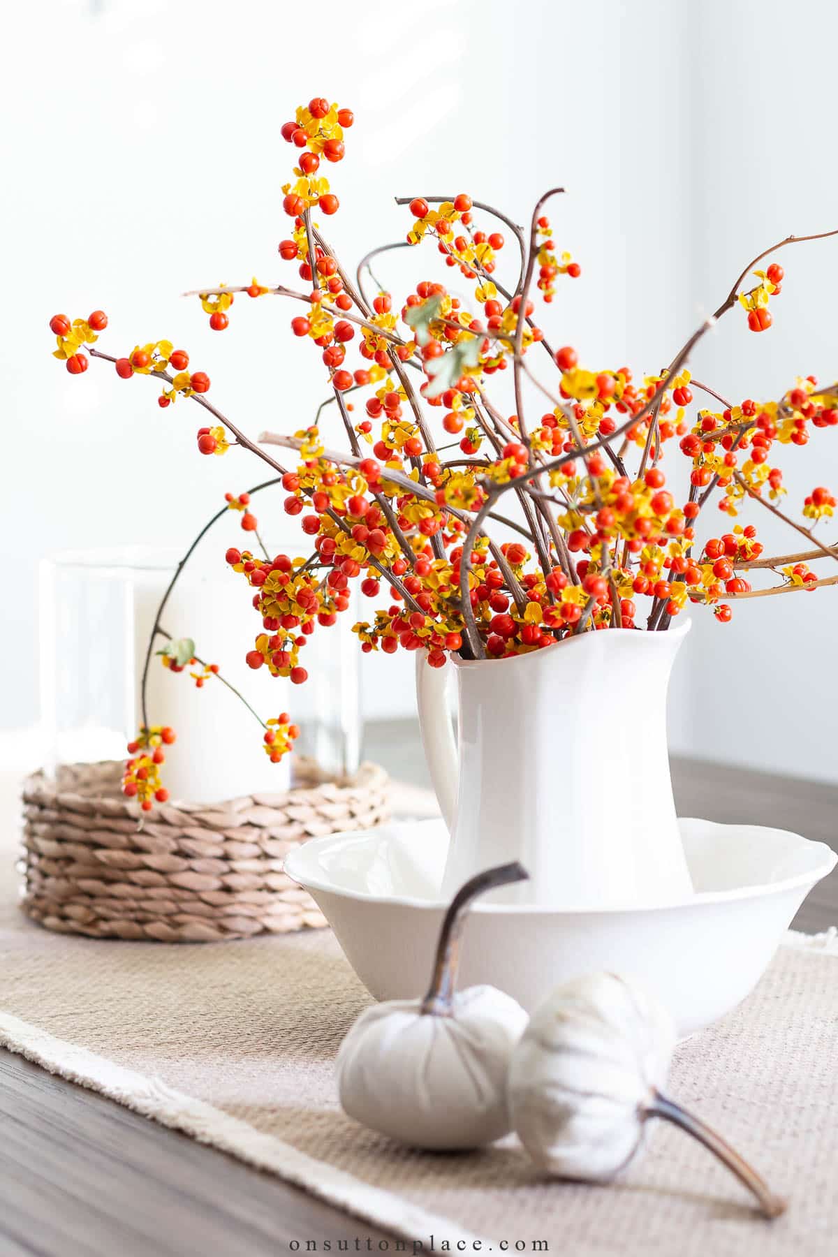 bittersweet in small pitcher with tiny pumpkins halloween decor ideas