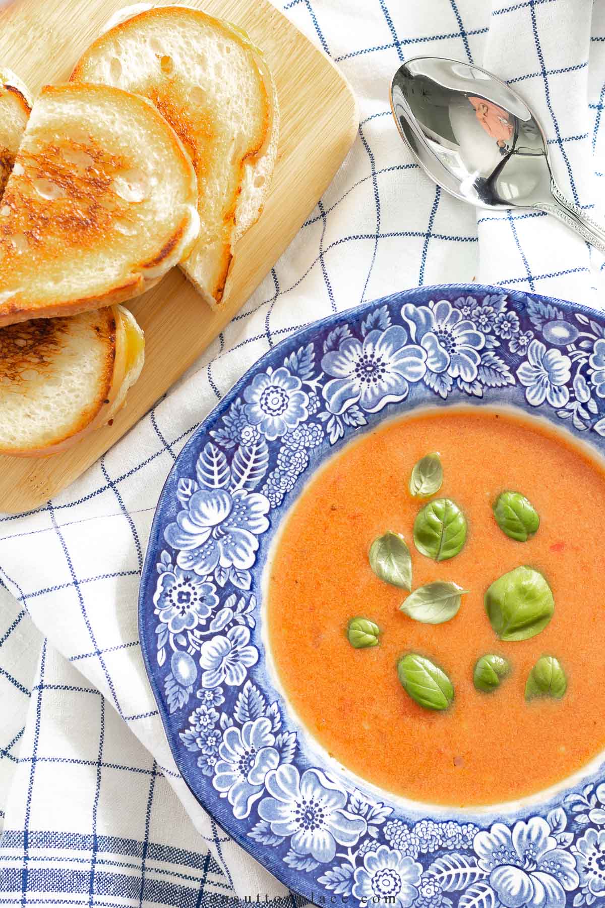 bowl of cream of tomato soup with grilled cheese