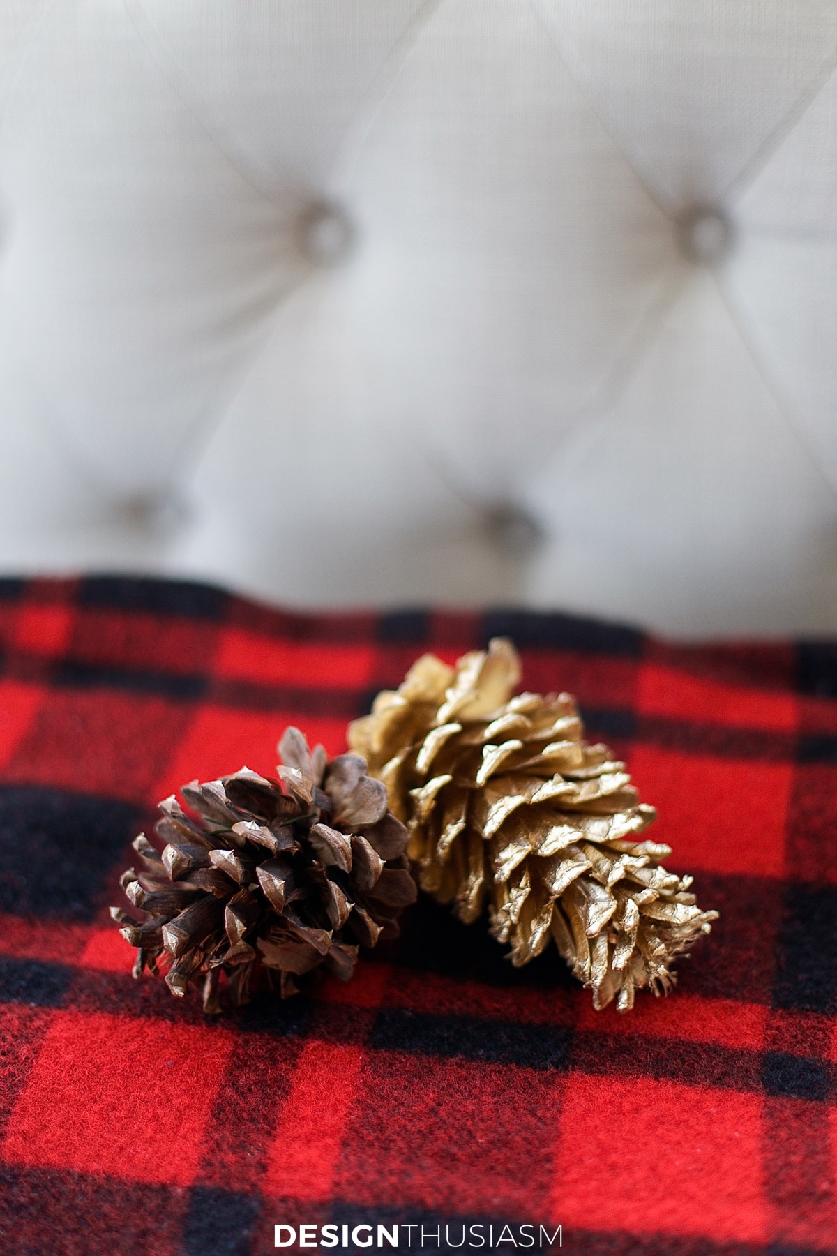 Christmas decor gold pine cones on a plaid blanket
