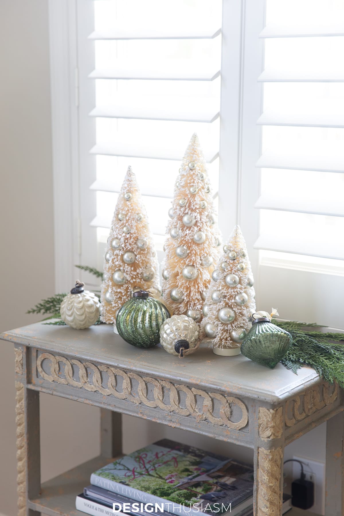 accent table with bottle brush trees and ornaments