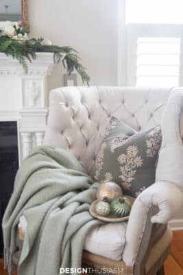 tufted romantic chair next to holiday mantel