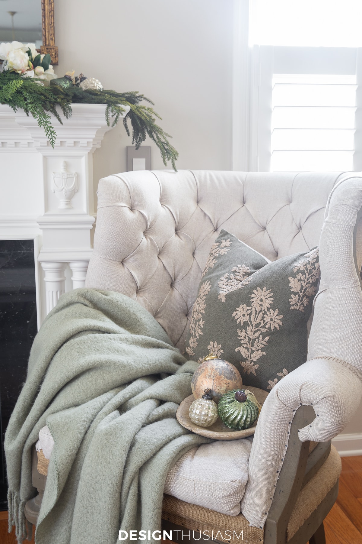 tufted romantic chair next to holiday mantel