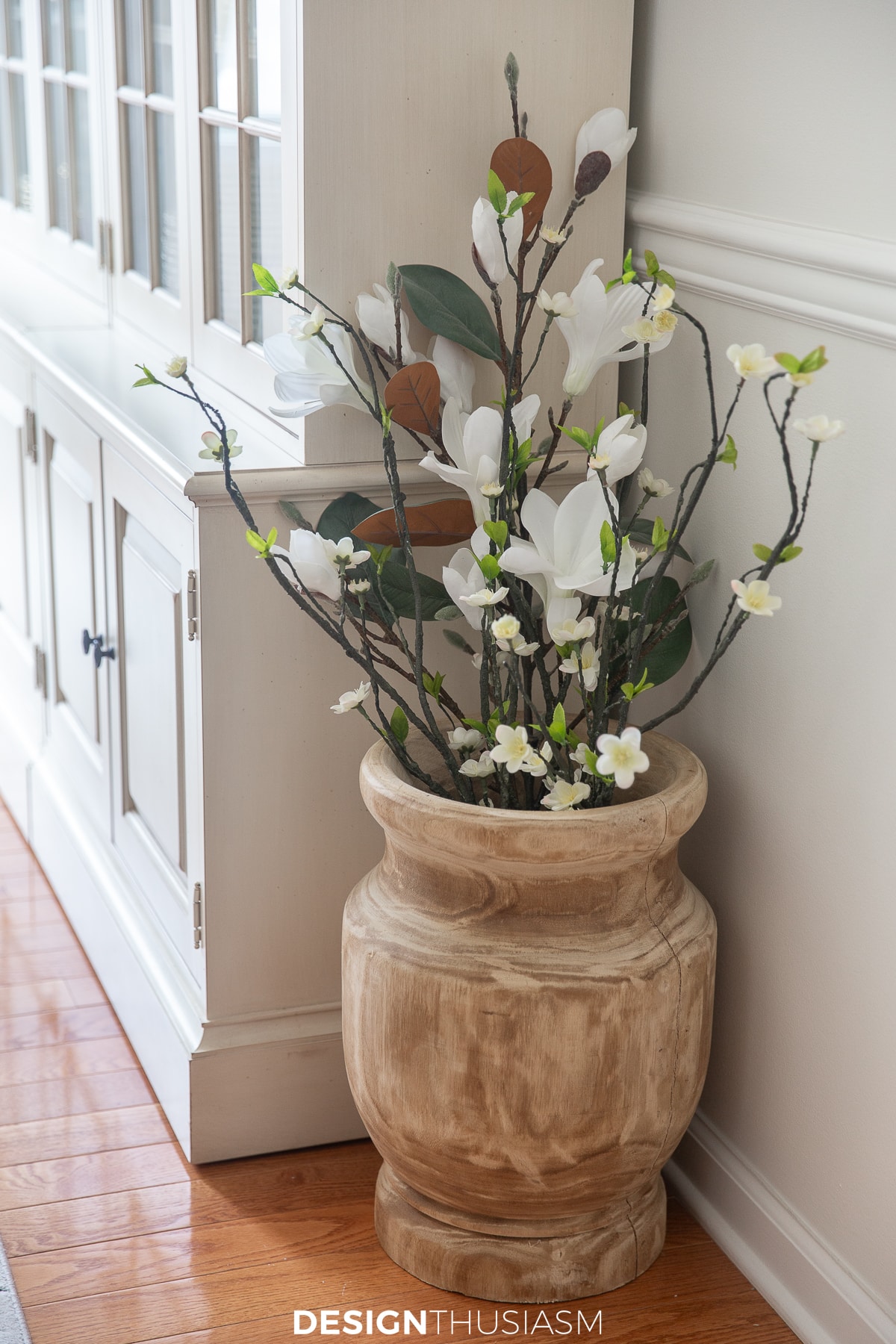 white cherry blossoms in a wood urn