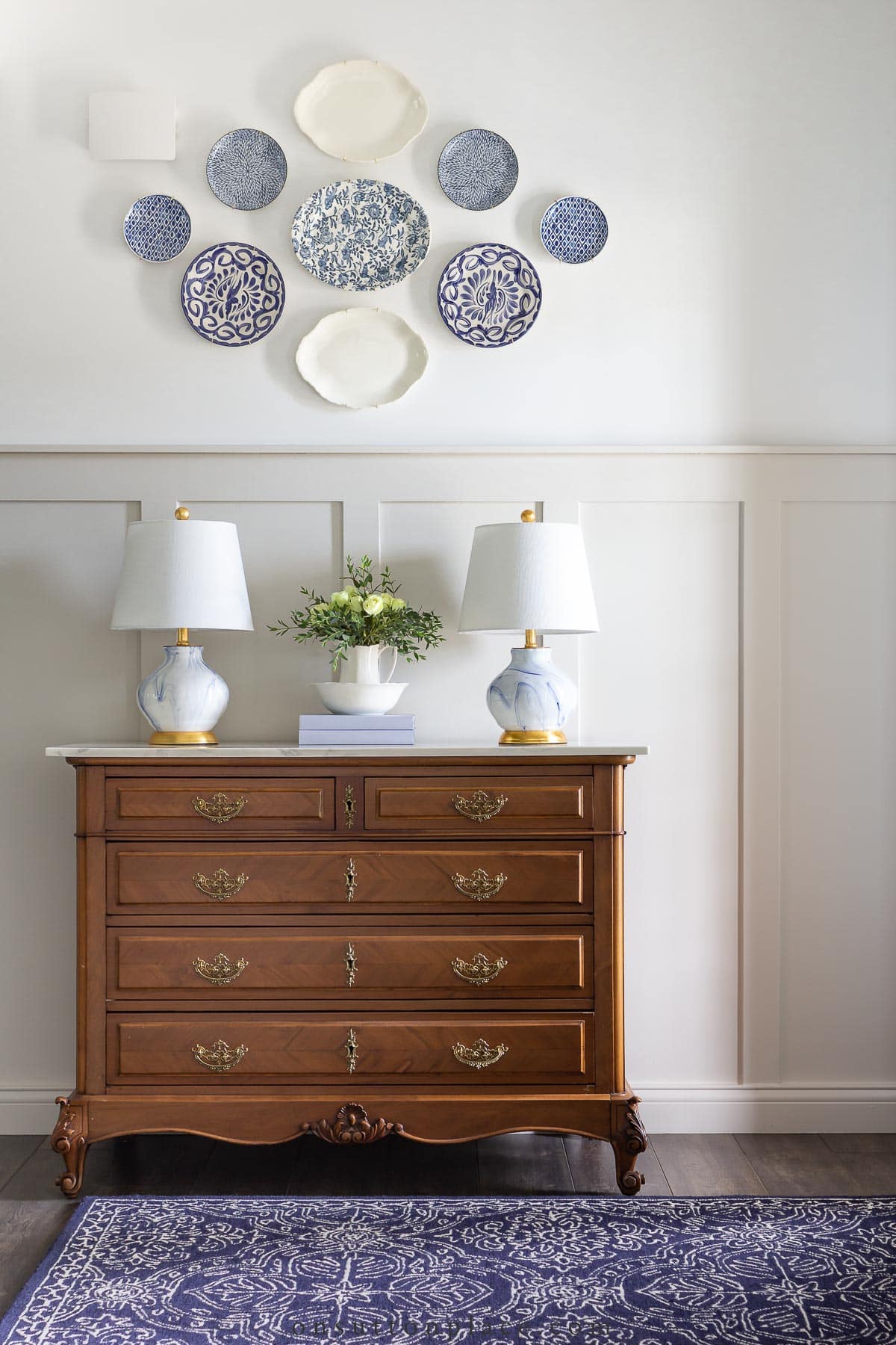 antique dresser in foyer with board and batten wall