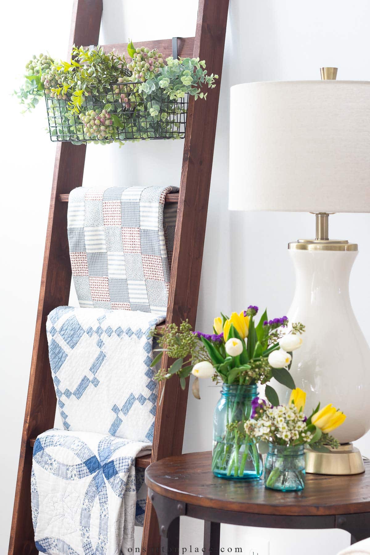 vintage quilts on blanket ladder decorating with collections
