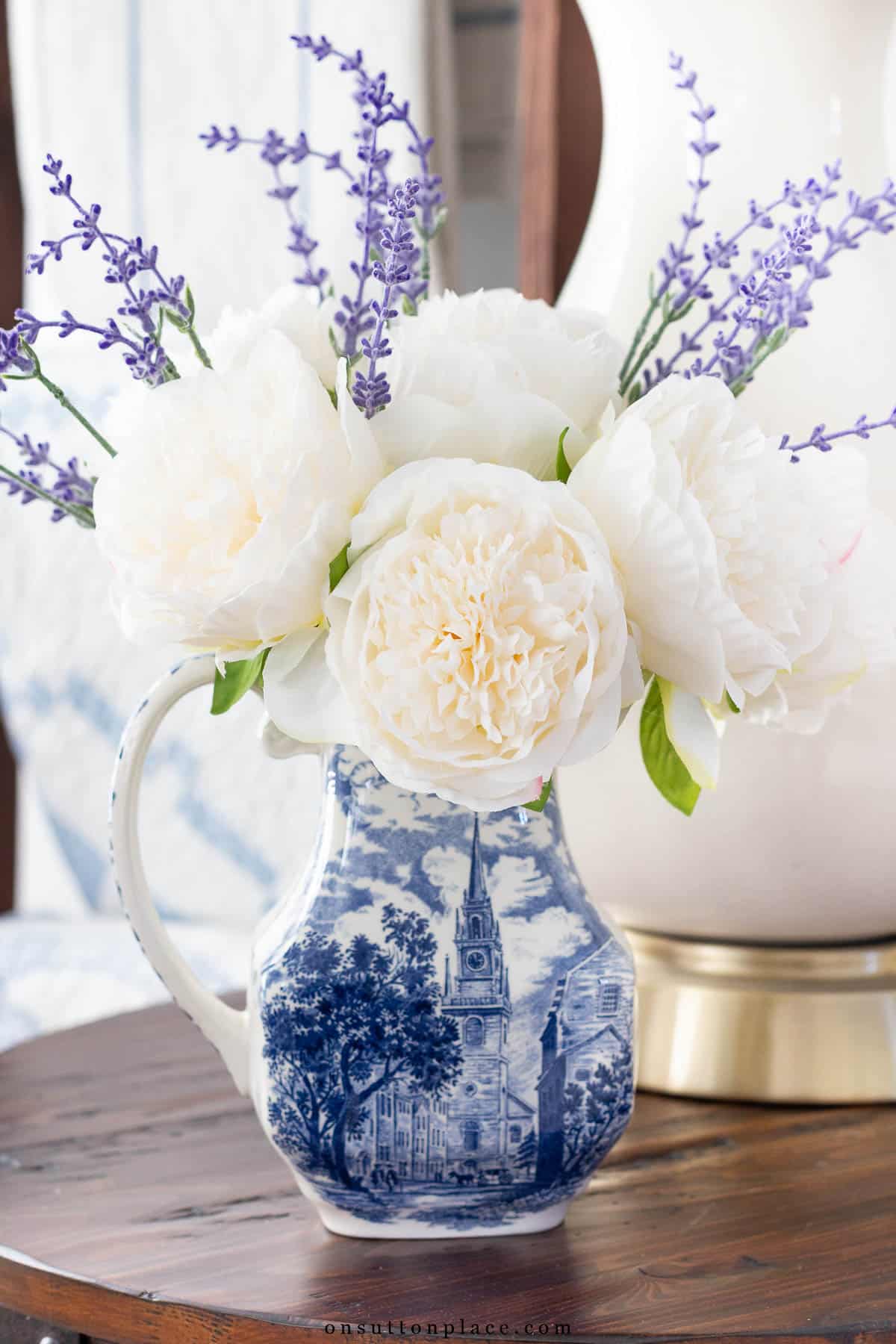 white faux peonies in liberty blue pitcher with faux lavender