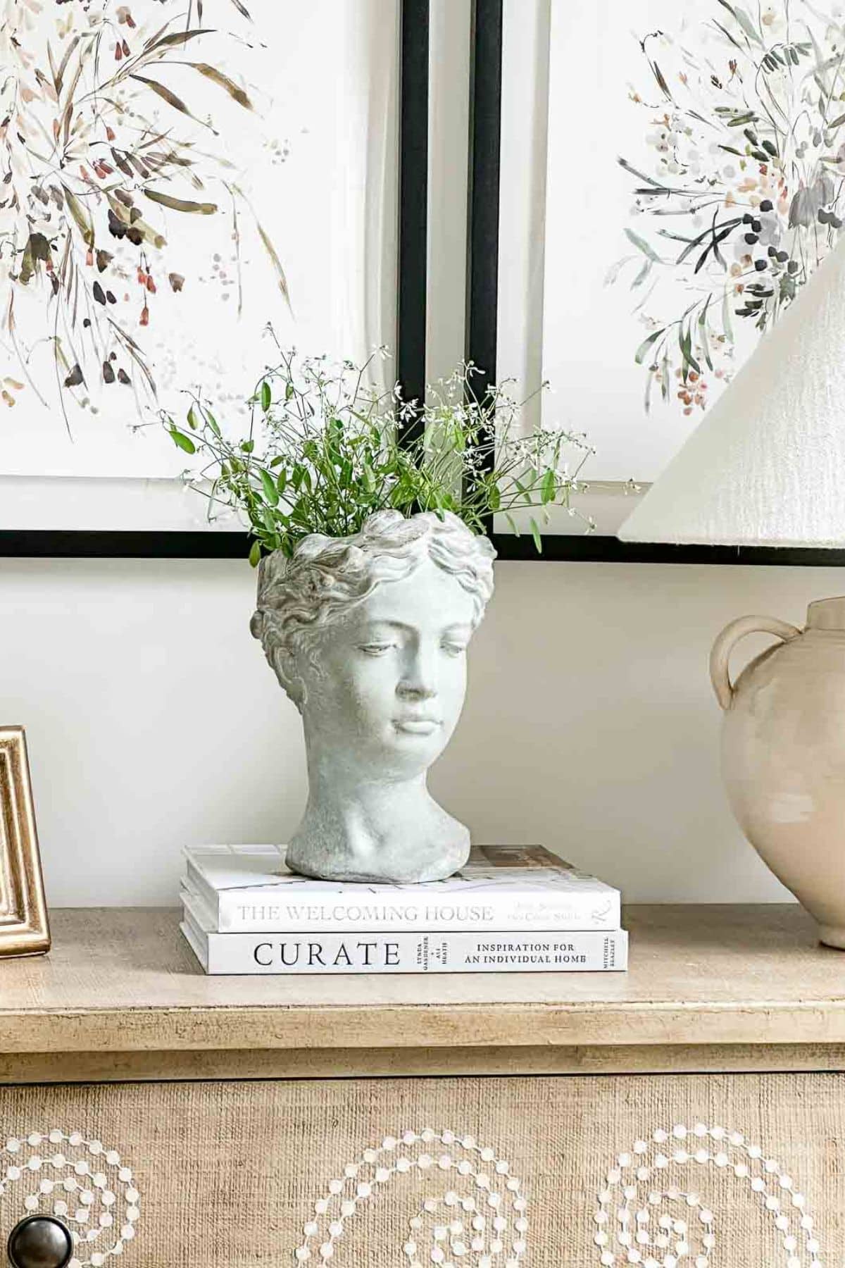 Grecian bust planter on a bureau