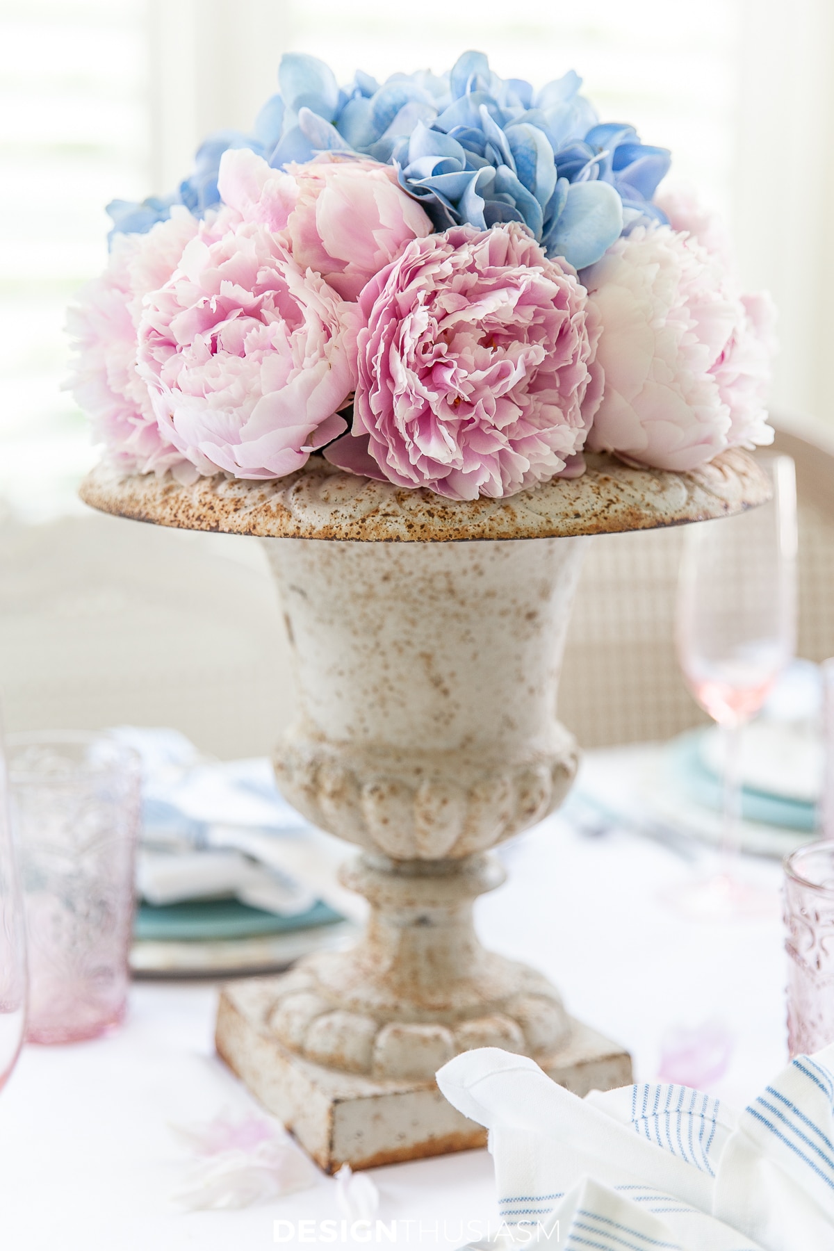 pink peonies in a vintage garden urn