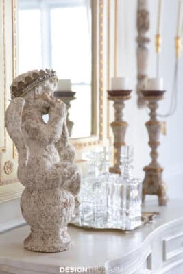 garden statue, decanter and candlesticks in the sideboard