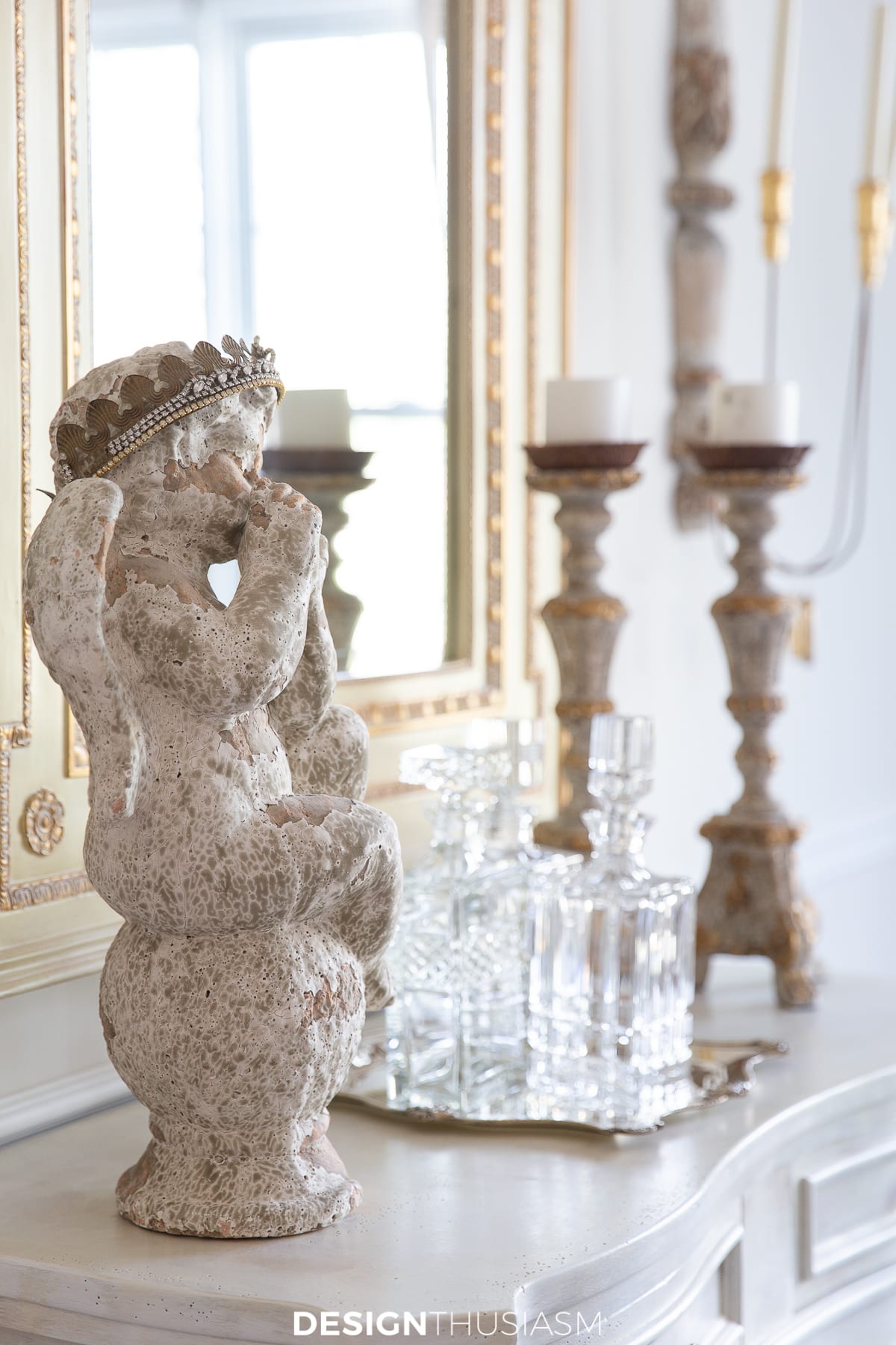 garden statue, decanter and candlesticks in the sideboard