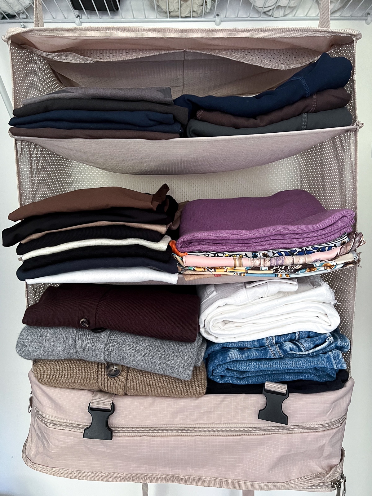 Hanging Closet Storage 3-Shelf Bag with folded clothing