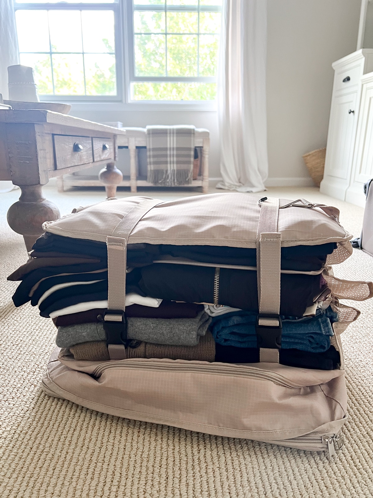 Hanging Closet Storage 3-Shelf Bag filled with clothing, collapsed and belted