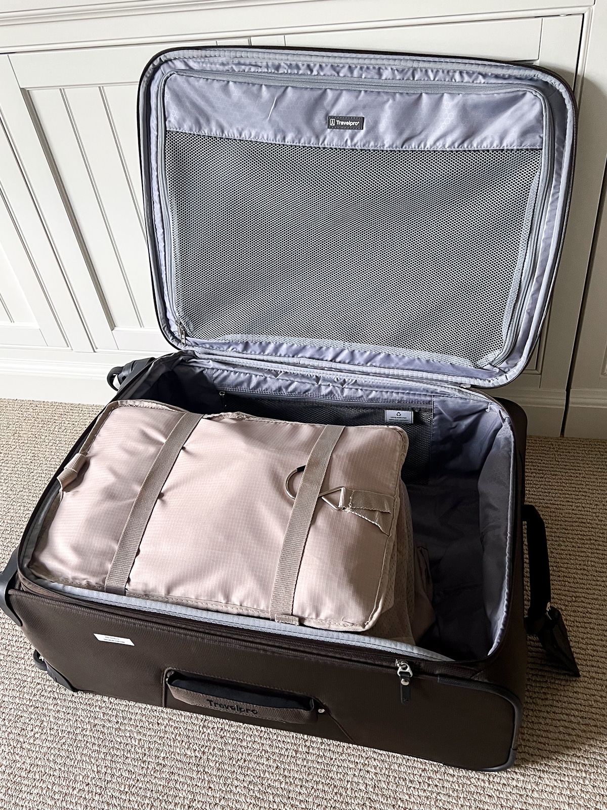 Hanging Closet Storage 3-Shelf Bag, collapsed and put in medium suitcase